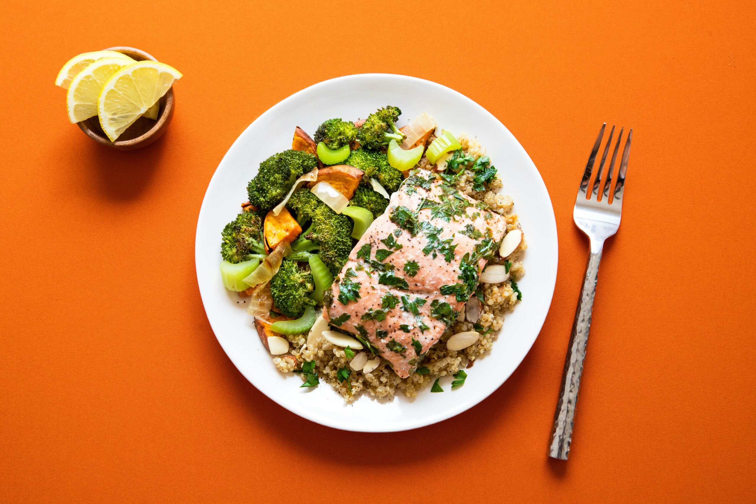 Photo collage showcasing food items high in carnitine such as steak, chicken breast, and avocados.